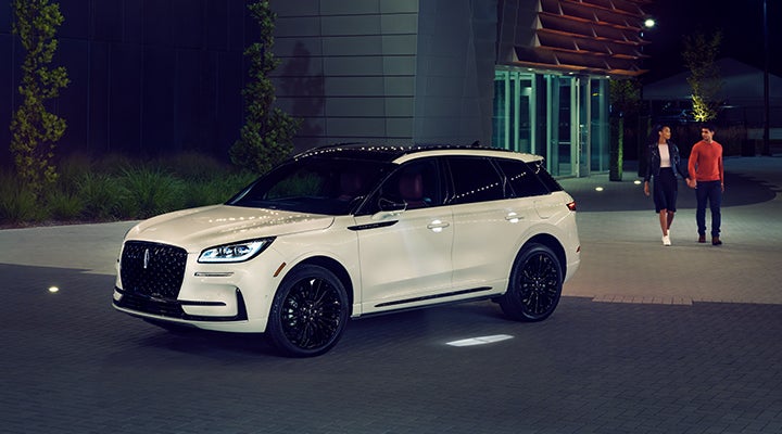 Two people approach a 2024 Lincoln Corsair® SUV featuring the available Jet Appearance Package. | Buss Lincoln in McHenry IL