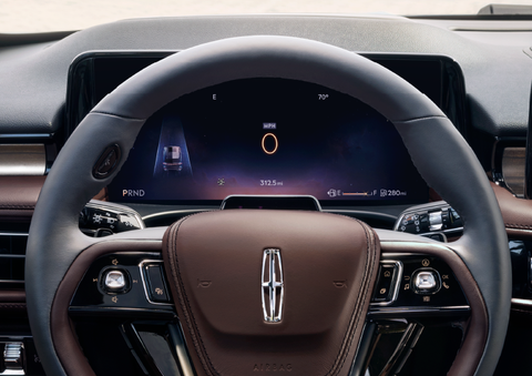 The steering wheel of 2025 Lincoln Aviator® SUV is shown with black and brown accents. | Buss Lincoln in McHenry IL