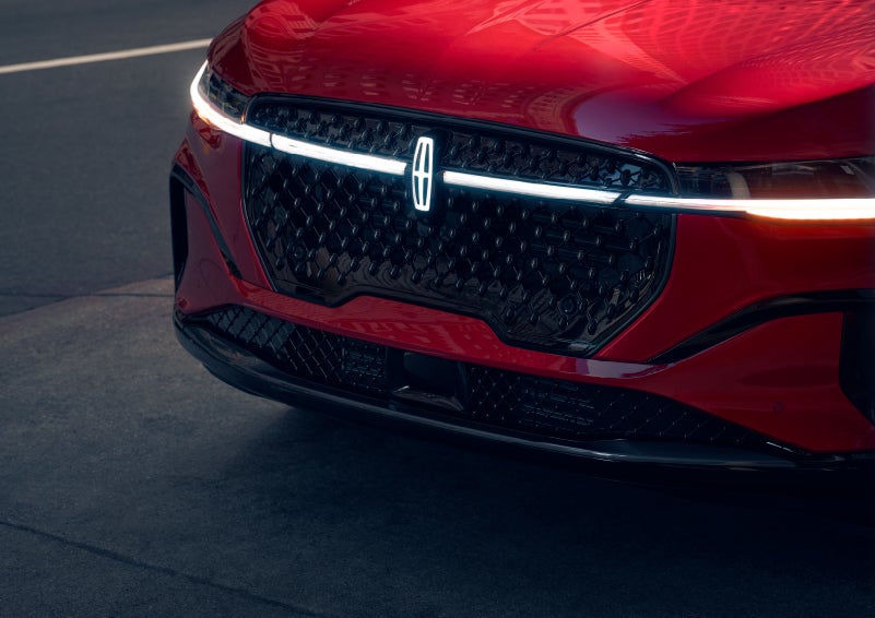 The available front LED light bar and center Lincoln Star logo glow at dusk. | Buss Lincoln in McHenry IL