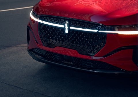 The available front LED light bar and center Lincoln Star logo glow at dusk. | Buss Lincoln in McHenry IL