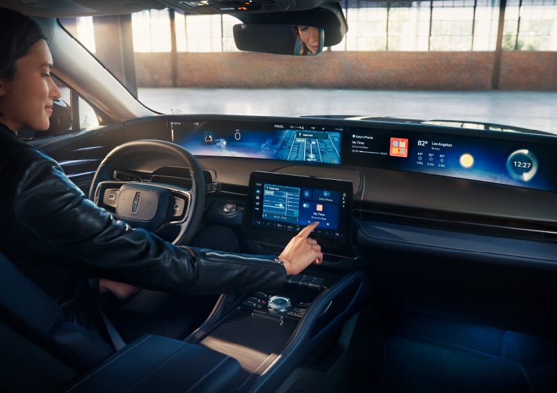 The driver of a 2025 Lincoln Nautilus® SUV interacts with the center touchscreen. | Buss Lincoln in McHenry IL