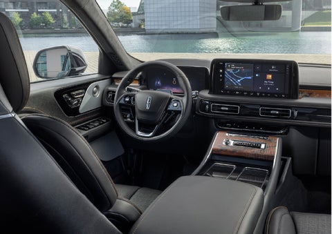The interior of the 2026 Lincoln Aviator® SUV is shown parked with a view of a harbor through the windshield. | Buss Lincoln in McHenry IL