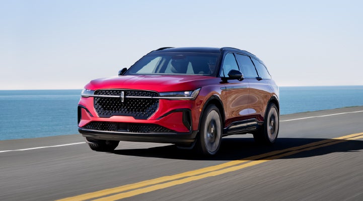 A 2026 Lincoln Nautilus® SUV is being driven on a seaside roadway. | Buss Lincoln in McHenry IL