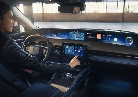 The driver of a 2026 Lincoln Nautilus® SUV interacts with the center touchscreen. | Buss Lincoln in McHenry IL