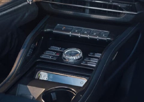 A smartphone is shown charging in the wireless charging pad. | Buss Lincoln in McHenry IL