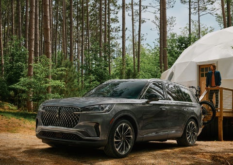 A 2027 Lincoln Aviator® is parked next to a high end glamping site. | Buss Lincoln in McHenry IL