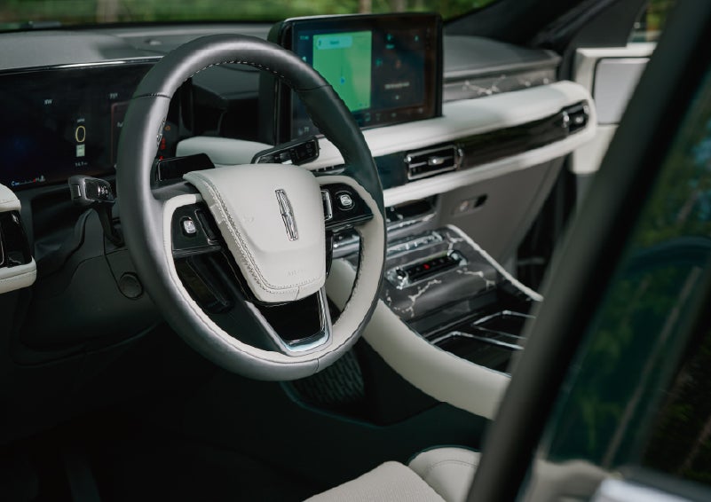The leather-trimmed steering wheel of a 2027 Lincoln Aviator® Black Label™ SUV. | Buss Lincoln in McHenry IL
