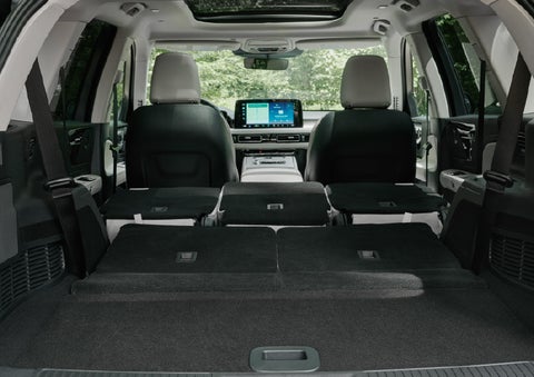 A rear to front view of the interior of a 2027 Lincoln Aviator® Black Label™ SUV shows the third and second rows folded flat | Buss Lincoln in McHenry IL