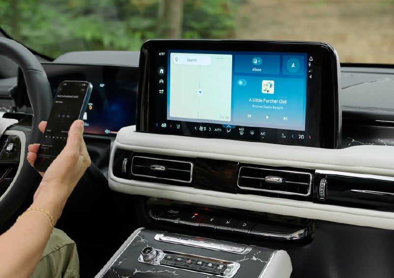 A person pairs thier phone with the center touchscreen of a 2027 Lincoln Aviator® Black Label™ SUV | Buss Lincoln in McHenry IL